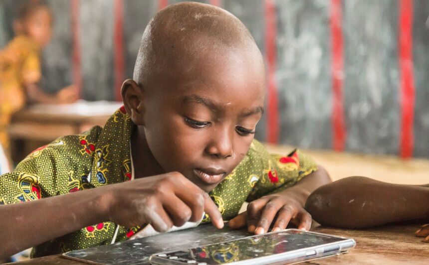 A child uses a tablet computer in a classroom