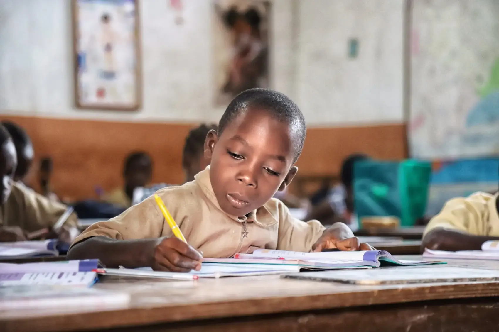A pupil working in their books in class