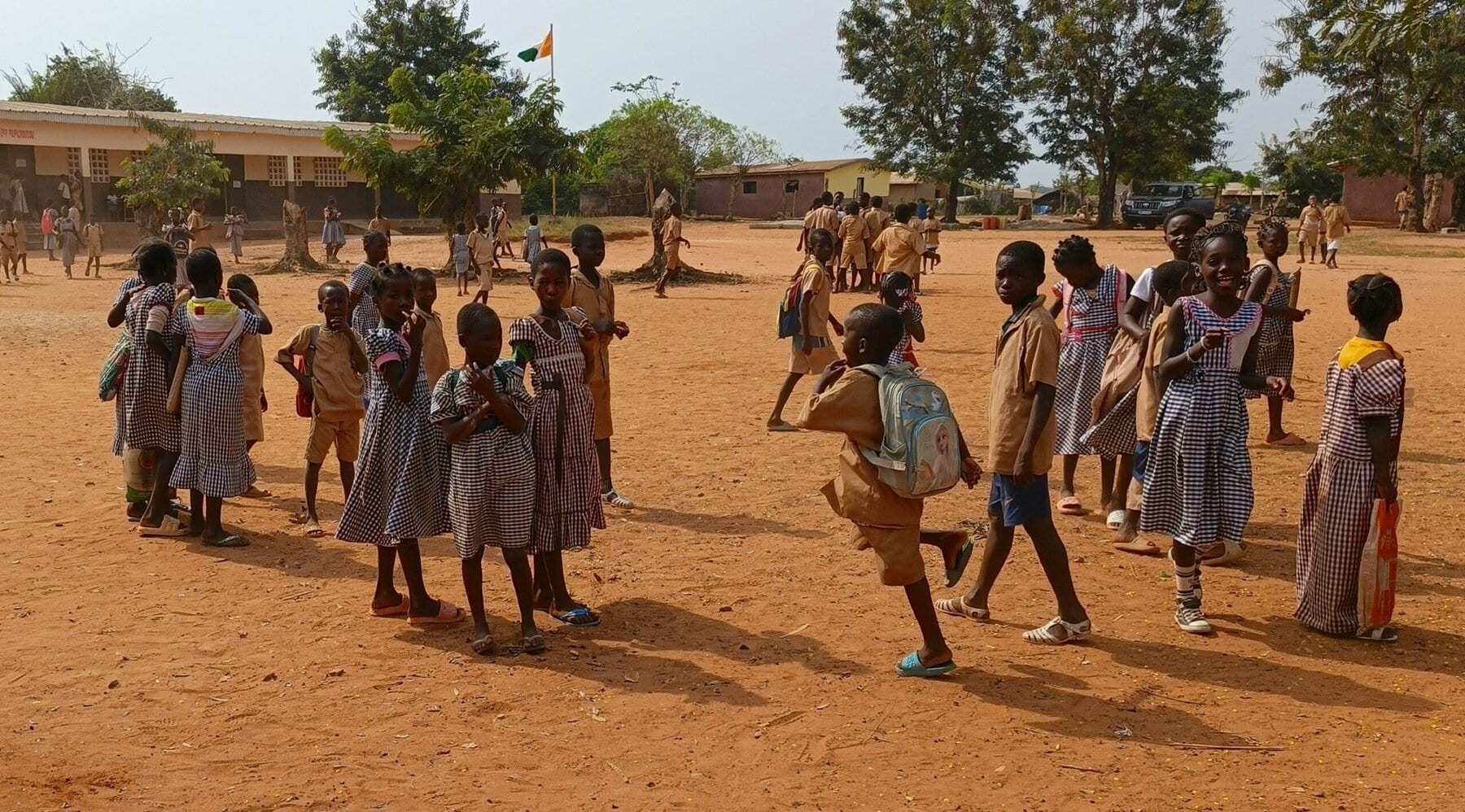 Children playing outside a school in Côte d’Ivoire where CLEF operates.